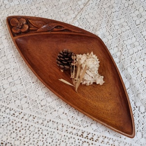 Hand carved wooden bowl. Floral detail.