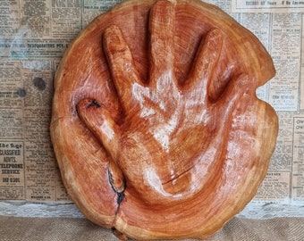 Carved hand plaque.