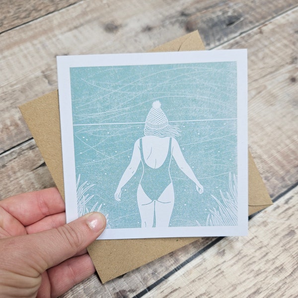 Braced - Single Square Greetings Card with recycled brown envelope (blank inside) featuring a woman swimming outdoors in cold winter weather