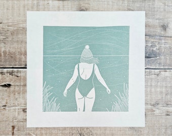 Braced - Original linocut print of a woman bracing herself before going for a swim on a cold windy day