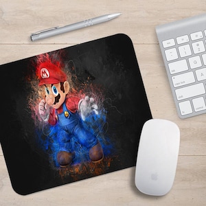 May include: A black mousepad with a colorful illustration of Mario, a video game character, in a fighting pose. The background is a mix of red, orange, and blue.