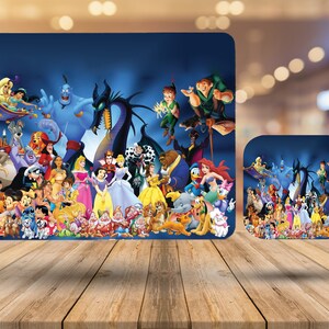 May include: A blue mousepad and coaster set featuring a collage of Disney cartoon characters. The design includes characters from various Disney movies, such as Aladdin, Snow White, and Peter Pan, against a blue background. The set is displayed on a wooden surface.