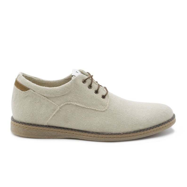 May include: A pair of beige canvas lace-up shoes with brown laces and a brown rubber sole.
