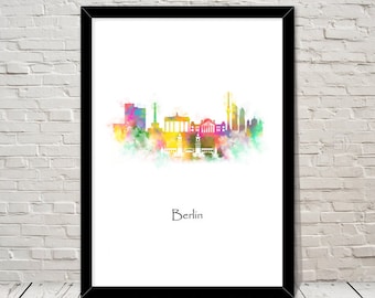 May include: A framed print featuring a colorful watercolor skyline of Berlin. The artwork showcases iconic landmarks in shades of pink, yellow, green, and blue against a white background. The word "Berlin" is written in black script below the skyline.