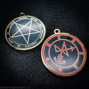 May include: Two gold-coloured metal sigils with black enamel and red lettering. The sigil on the left has a five-pointed star with the text "Potius quam ad Inferos regnabit in Serve", and the sigil on the right has a symbol with an arrow and the text "N B H D O D".