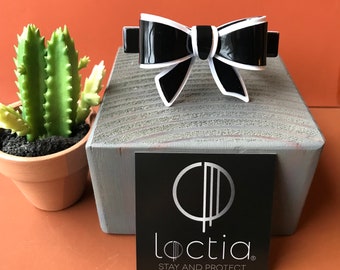 Loctia lined no slip small black acetate bow barrette hair clip with white accent. Great for fine hair too.