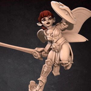 Puede incluir: Una figura en miniatura de una guerrera hada, pintada en color marrón claro. El hada lleva armadura y sostiene una espada y un escudo. El hada tiene el pelo rojo y alas. La figura está de pie sobre una base de tronco de árbol.
