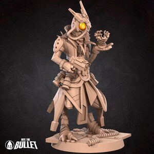 May include: A detailed, beige-colored figurine of a futuristic humanoid character, holding a gun and a small, intricate object. The figure has a large, yellow eye and mechanical details. The base of the figurine has the text "Bite the Bullet".