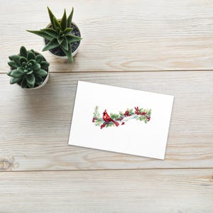 Lindo cartão postal padrão de cardeal de Natal em um galho