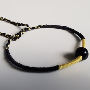 Rundes brasilianisches Armband und symbolische Perle