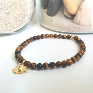 Minimalist protection bracelet made of tiger&#39;s eye stone beads.