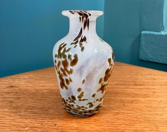 A Hand Blown Vase in Leopard Print on a Smoky White Background