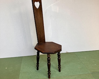 A Dark Oak Spinning Chair with Heart Motif