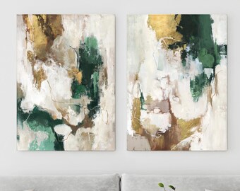 May include: Two rectangular canvas wall art pieces featuring abstract brushstrokes in shades of forest green, metallic gold, cream, and taupe. The compositions display layered paint textures with thin, delicate line work throughout the surfaces.