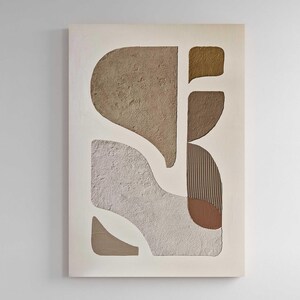 May include: A rectangular wall art piece featuring abstract shapes in shades of beige, tan, brown, and cream. The composition includes textured surfaces with rough, sandy finishes alongside sections with vertical linear grooves and smooth areas.