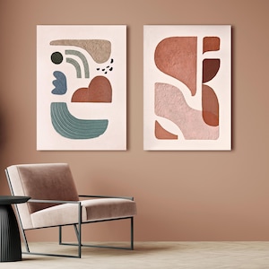 May include: Two rectangular wall art pieces featuring textured abstract shapes in shades of terracotta, sage green, dark brown, and light pink on a pale background. The artwork displays various organic forms with raised surfaces and linear patterns.