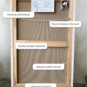 May include: The back of a stretched canvas painting with a wooden frame. The canvas is made of natural cotton and is attached to the frame with staples. The frame is white and has a label with the text "Motils Art Studio" and contact information. The painting is ready to hang with included fasteners.