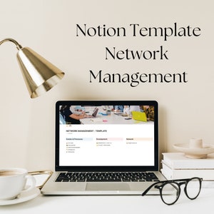 May include: A laptop computer displaying a Notion template for network management. The template is divided into three sections: Guides & Processes, Development, and Network. The laptop is on a white desk with a gold lamp, a cup of coffee, a stack of books, and a pair of glasses.