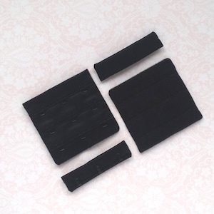 May include: Four black bra strap adjusters, including a hook and eye closure, a strap extender, and two separate straps.