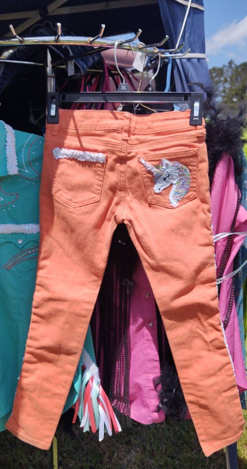 Little girls orange skinny jeans with unicorns!