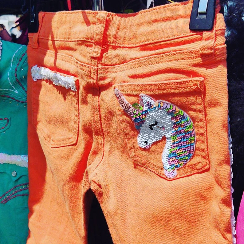 Little girls orange skinny jeans with unicorns!