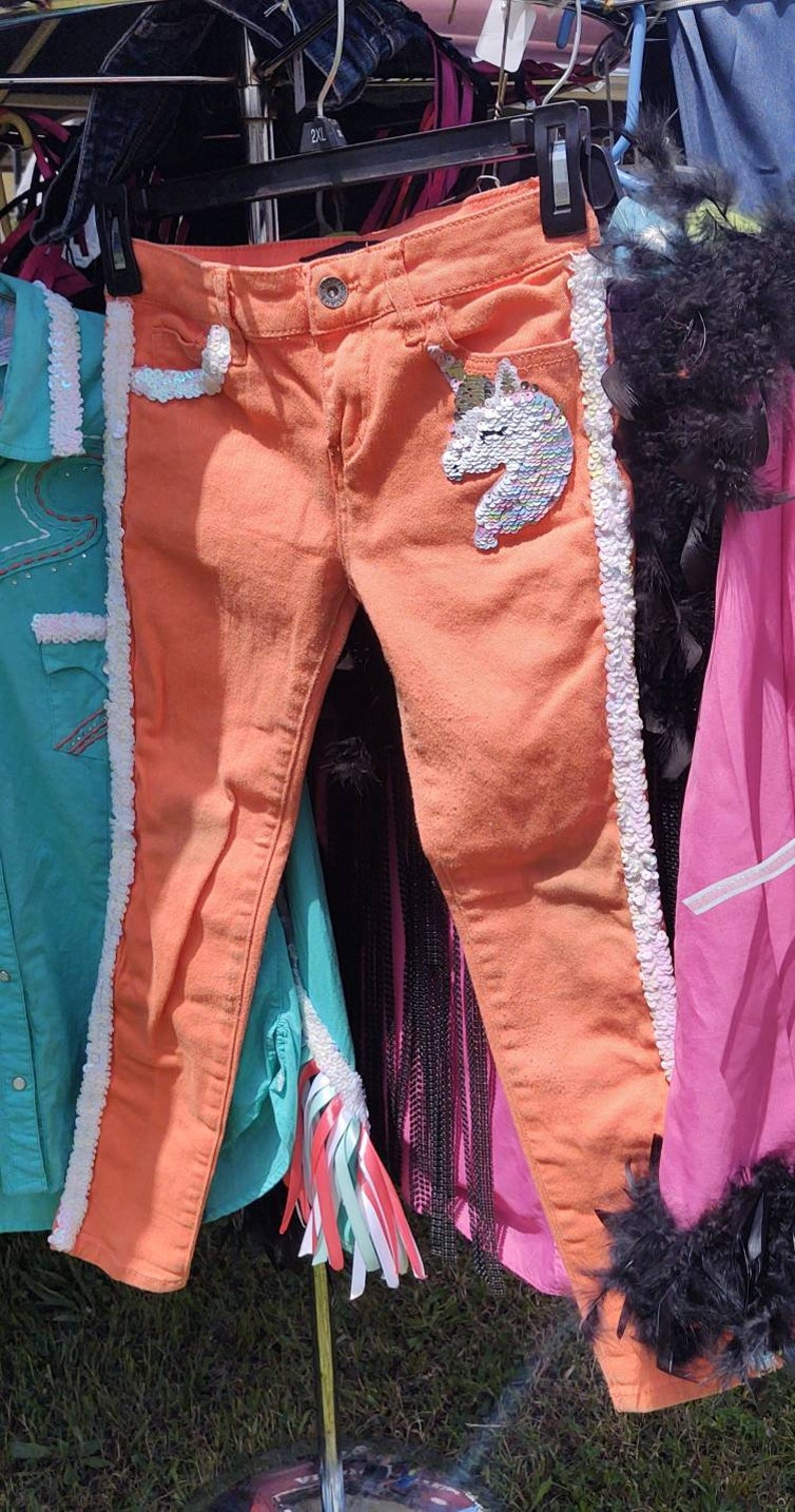 Little girls orange skinny jeans with unicorns!