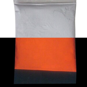 Puede incluir: Una bolsa de pl&aacute;stico blanca llena de polvo gris, con una capa naranja brillante en la parte superior. La bolsa est&aacute; sellada en la parte superior.
