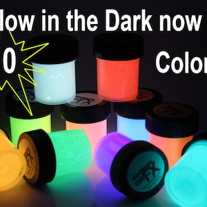 May include: Image of ten jars of glow-in-the-dark powder in various colors, including white, orange, green, pink, purple, and blue. Each jar has a black lid. Text reads "Glow in the Dark now in 10 Colors."