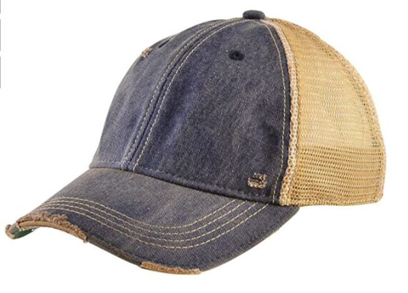 May include: A distressed blue denim baseball cap with a brown mesh back panel. The cap has a slightly curved brim and a distressed look.