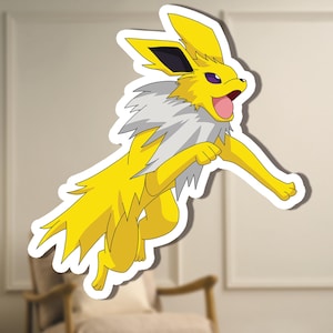 May include: A yellow cartoon character sticker with a white border, shown in a running pose. The character has spiky yellow fur, a white and grey neck, and purple eyes. The background is blurred, showing a chair and wall.