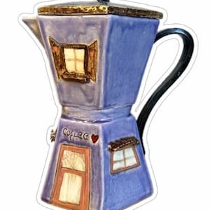 May include: A purple ceramic coffee pot shaped like a house with a red door and windows. The pot has a black handle and a gold lid. The words "Coffee" and a heart are painted on the front of the pot.