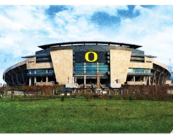 May include: A large, modern stadium with a yellow "O" on the front. The stadium is made of concrete and glass and has a large, open field in front of it.