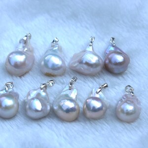 May include: A collection of eight iridescent white baroque pearl pendants with silver clasps. The pearls are various shapes and sizes.