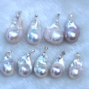 May include: Ten white and iridescent baroque pearl pendants with silver bail settings. The pearls are various shapes and sizes.