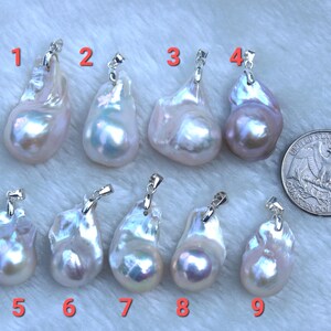 May include: Nine white and lavender baroque pearl pendants with silver bail settings. The pearls are irregular in shape and have a high lustre.
