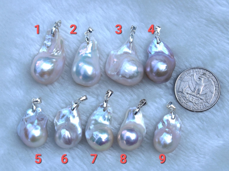 May include: Nine white and lavender baroque pearl pendants with silver bail settings. The pearls are irregular in shape and have a high lustre.