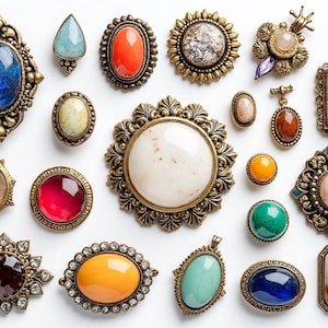 May include: Assortment of vintage brooches with various colored stones and metal settings. The brooches feature a variety of designs, including floral, geometric, and abstract patterns.