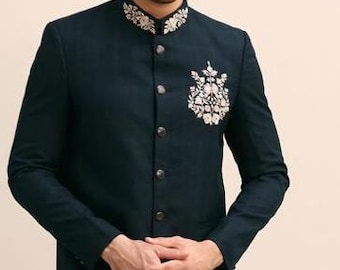 May include: A dark blue blazer with a mandarin collar and silver embroidery. The embroidery features a floral design on the left side of the chest.