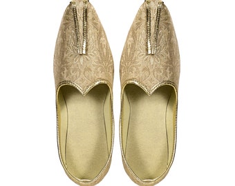 May include: A pair of gold embroidered flat shoes with tassels. The shoes have a pointed toe and a slip-on design.