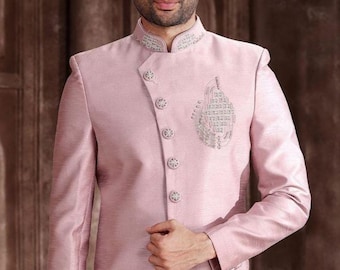 May include: A pale pink suit jacket with a mandarin collar and silver embroidery. The jacket has decorative buttons and an embroidered design on the front. This formal jacket is suitable for special occasions. The jacket is a formal wear item.