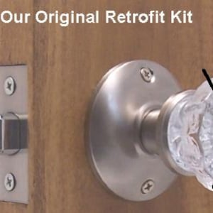 May include: A door knob and latch set with a clear, faceted glass knob and a brushed nickel finish. The set is mounted on a wooden door. The text "Our Original Retrofit Kit" is visible at the top.