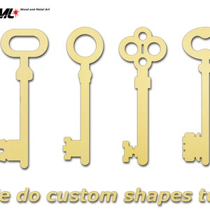 May include: Four different wooden key shapes, all in a gold color. The keys are arranged in a row from left to right. The text "We do custom shapes too" is at the bottom of the image.