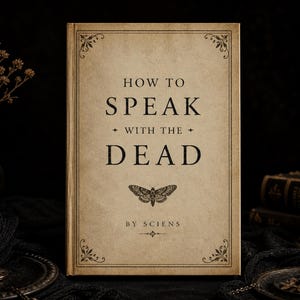 May include: A hardback book with the title "HOW TO SPEAK WITH THE DEAD" and a moth illustration on the cover. The book has a beige cover with black text and decorative corner designs. A lit black candle sits in a brass candlestick.