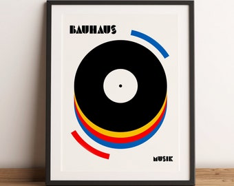 May include: A black and white poster with the text "BAUHAUS MUSIK" in bold black letters. The poster features a stylized black vinyl record with concentric circles of red, yellow, and blue.