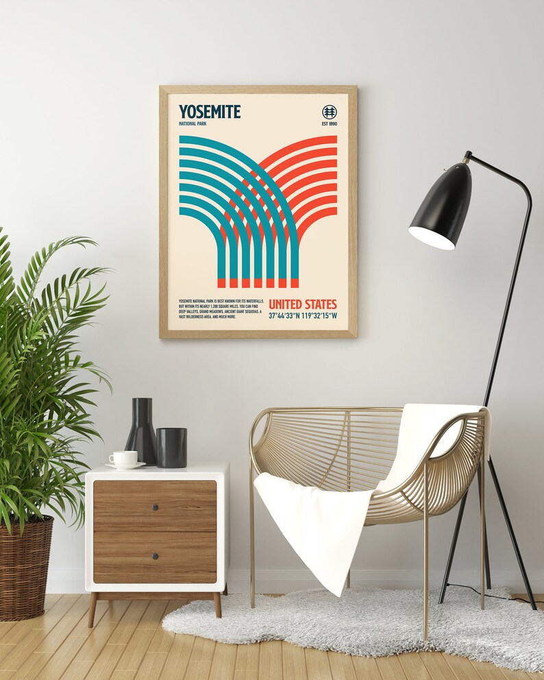 May include: Framed poster featuring a retro design for Yosemite National Park. The artwork includes the park's name, coordinates, and a stylized graphic in teal and red. The poster is displayed in a light wood frame.