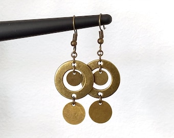 May include: Gold tone dangle earrings with two round discs and a smaller circle in the center of each disc.