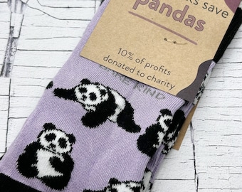 May include: Purple socks with a black and white panda print. The socks have a tag that says "Bare Kind" and "These socks save pandas". The tag also says "10% of profits donated to charity".