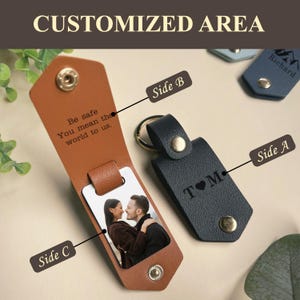 May include: A brown leather keychain with a photo insert and a personalized message. The message reads "Be safe You mean the world to us." The keychain also has a black leather side with the text "T&hearts;M".