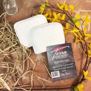 May include: Two white buffing pads for clay paint, with a card that reads "Terra Clay Paint Buffing Pad. After 24 hours buff the entire piece for a tough seal and shine. Dixie Bee."