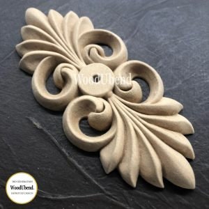 May include: A wooden decorative accent piece with a detailed, intricate design featuring swirling patterns and leaf-like shapes. The piece is unfinished and ready to be painted or stained.